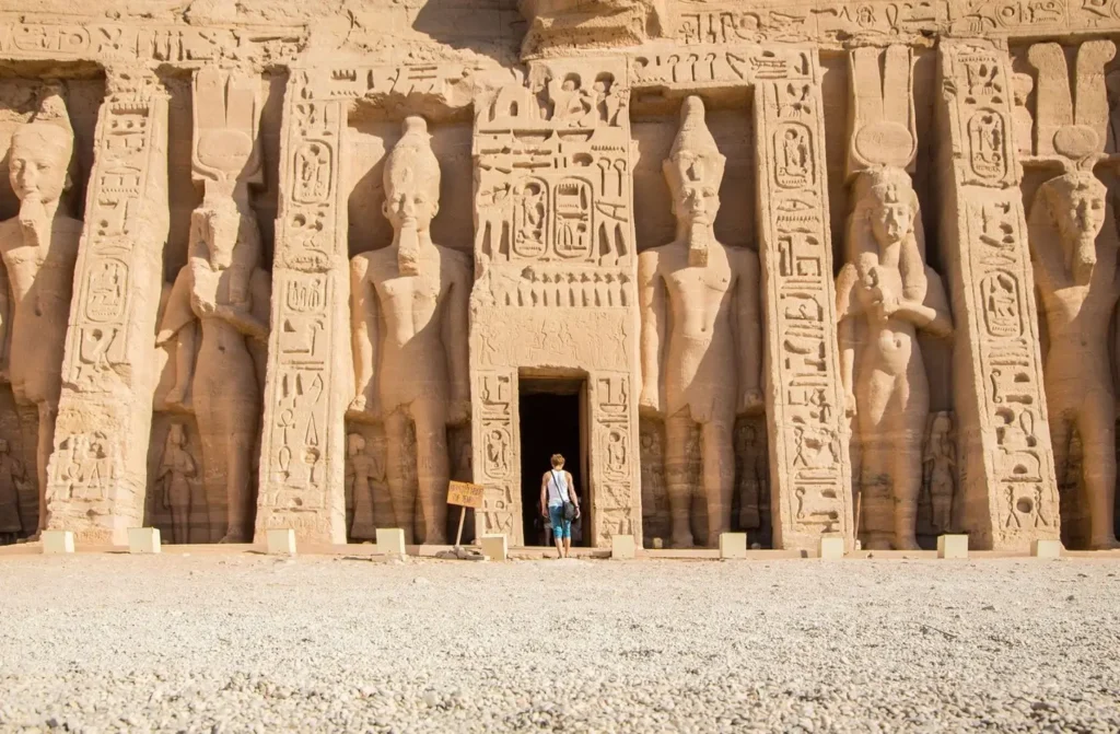 Tourist exploring the ancient Abu Simbel temple in Aswan, a key highlight for travelers planning how much does a trip to Egypt cost.