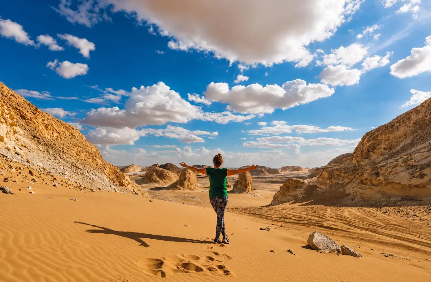 Traveler with arms wide open enjoying the White Desert safari during Egypt in October